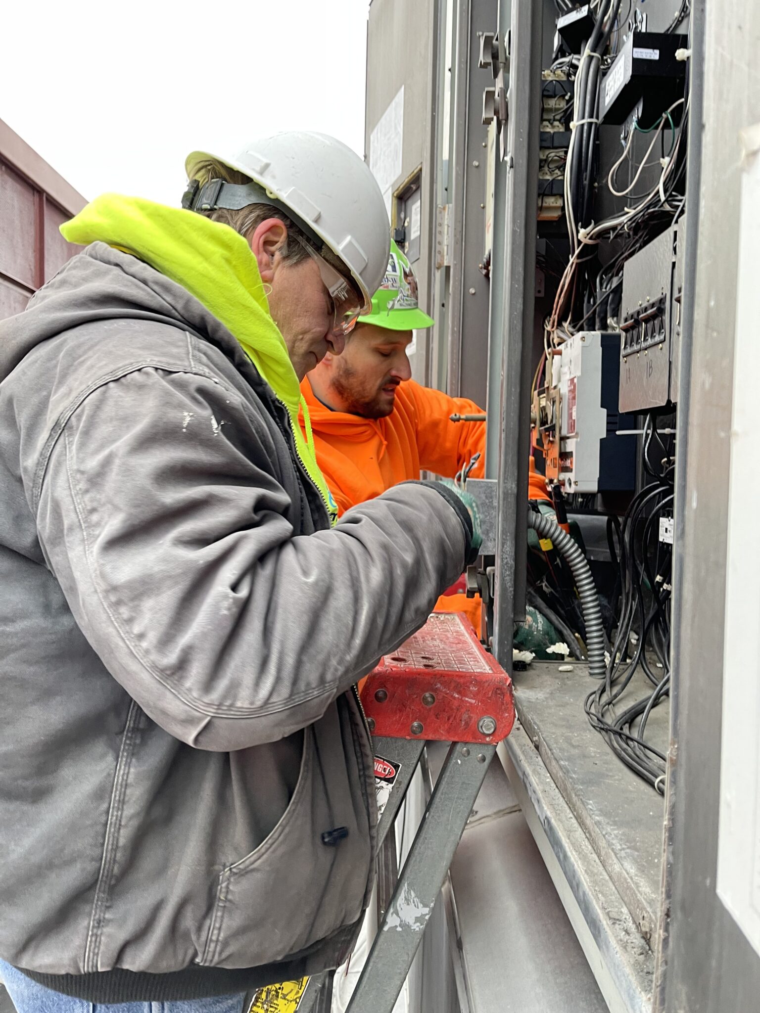 Omega Electricians disconnect the old units.