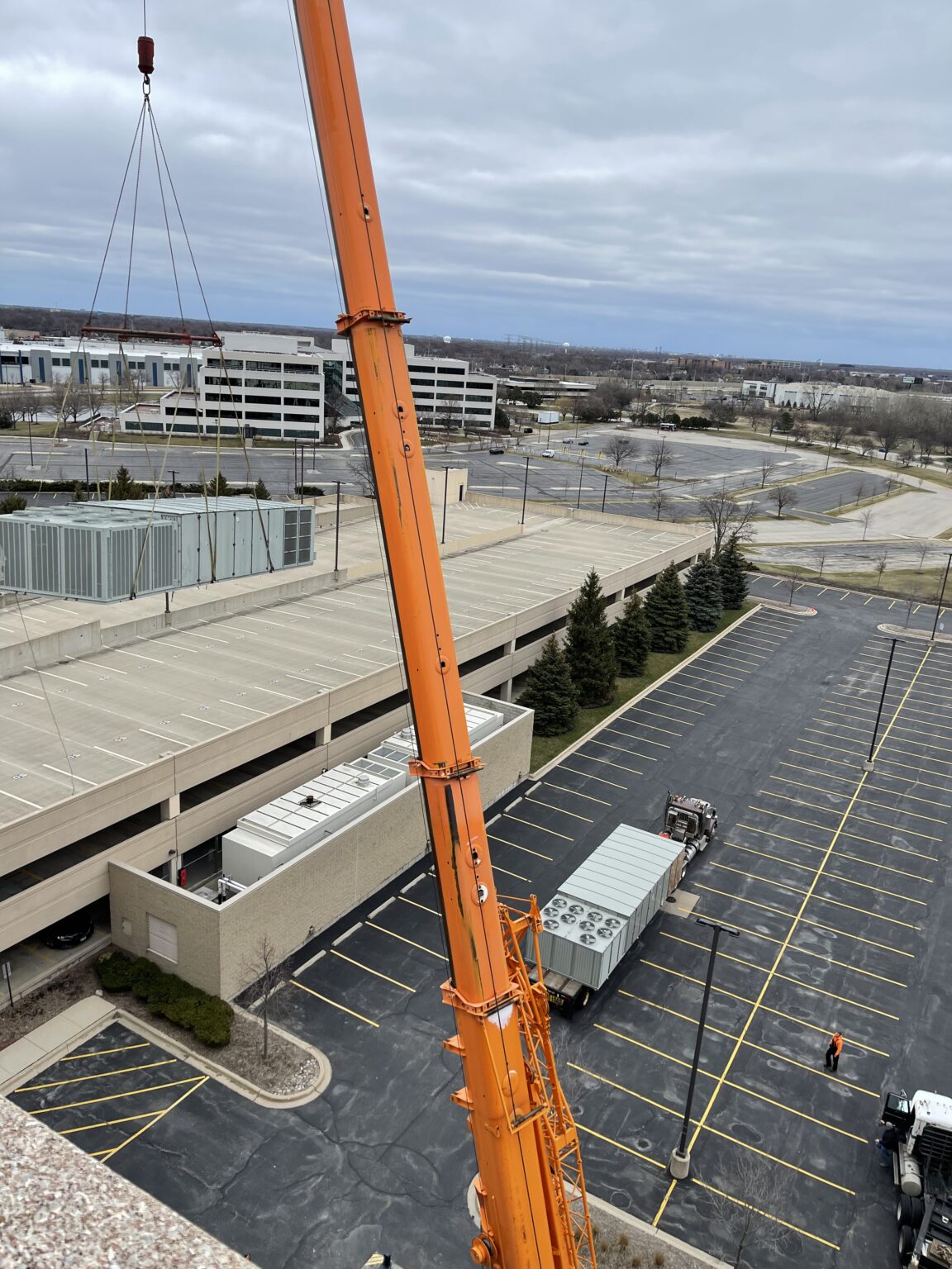 New Unit 2 waits as the old unit hangs in the air. New Unit 2 waits as the old unit hangs in the air.
