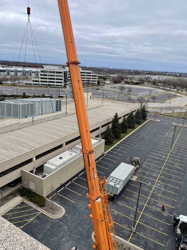 New Unit 2 waits as the old unit hangs in the air.