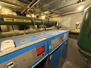Commercial Heating Boilers Before - Lake Point Tower Commercial boiler units and heating infrastructure in a Chicago high-rise mechanical room before upgrades.