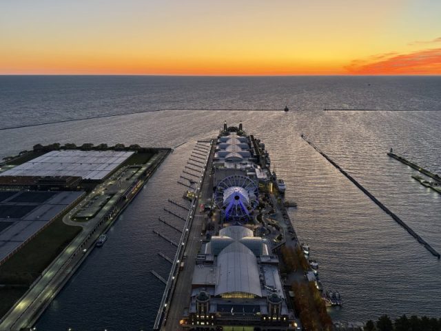 Chicago Navy Pier aerial view at sunrise featuring the Centennial Wheel and Jardine Water Plant.
