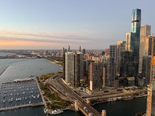 Lake Shore Drive - Southern View Aerial view of the Chicago skyline, DuSable Harbor, and Lake Shore Drive architecture at sunrise.