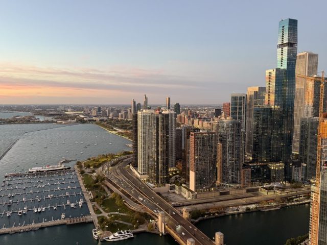 Aerial view of the Chicago skyline, DuSable Harbor, and Lake Shore Drive architecture at sunrise.
