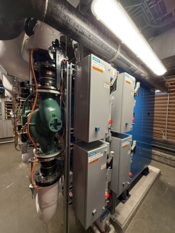 A detailed view of Siemens electrical control panels and motor starters powering the inline water pumps for the newly installed Patterson-Kelley boilers at Lake Point Tower.