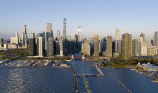 Chicago Commercial Real Estate - Downtown Skyline & River Lock Aerial Expansive aerial view of the downtown Chicago skyline and river lock from Lake Michigan, showcasing the city's premier commercial high-rise infrastructure.
