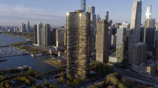 Chicago Commercial Real Estate - Lake Point Tower & Downtown Skyline Aerial Expansive daytime aerial view of Lake Point Tower prominently featured against the downtown Chicago skyline, showcasing dense commercial high-rise infrastructure along the lakefront.