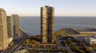 Chicago Commercial Real Estate - Lake Point Tower & Lakefront Aerial Expansive aerial view of Lake Point Tower glowing in the sunlight against the vast backdrop of Lake Michigan, highlighting Chicago's premier commercial high-rise real estate and lakefront infrastructure.