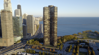 Chicago Commercial Real Estate - Lake Point Tower & John Hancock Center Aerial Expansive aerial view of Lake Point Tower and the John Hancock Center against the Chicago skyline, showcasing the city's dense commercial and residential high-rise real estate.