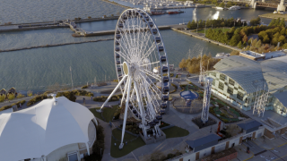 Chicago Municipal Infrastructure - Navy Pier Centennial Wheel Aerial High-angle aerial view of the Centennial Wheel and surrounding pavilion structures at Navy Pier, showcasing Chicago's large-scale commercial and municipal entertainment infrastructure.