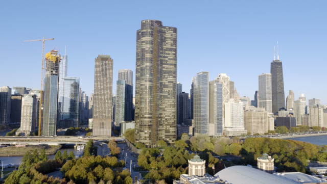 Wide daytime aerial view featuring Lake Point Tower and the dense commercial high-rise buildings along the Chicago River, highlighting the city's premier downtown real estate.