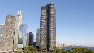 Chicago Commercial Real Estate - Lake Point Tower & Lakefront Park Aerial Stunning daytime aerial view of Lake Point Tower and the Chicago skyline, highlighting premier commercial real estate and lush lakefront park infrastructure along Lake Michigan.