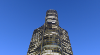 Chicago Commercial Real Estate - Lake Point Tower High-Rise Exterior Dramatic low-angle view looking up at the curved glass facade of Lake Point Tower against a blue sky, emphasizing the towering scale of Chicago's premier commercial and residential real estate.