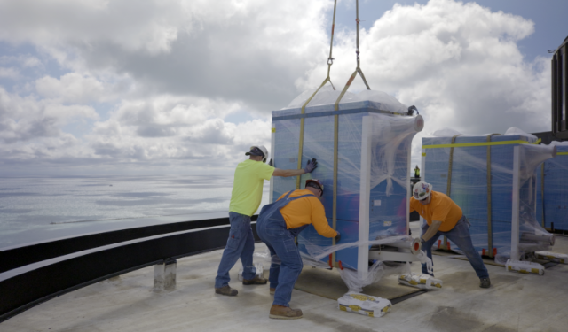 The final high-efficiency commercial boiler is successfully placed onto the rooftop of Lake Point Tower, officially concluding the massive aerial rigging phase of this Chicago HVAC upgrade.