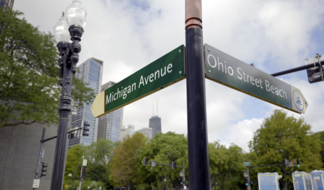Street signs for Michigan Avenue and Ohio Street Beach in downtown Chicago, highlighting the major intersection closed for complex commercial HVAC helicopter lift staging at Lake Point Tower.